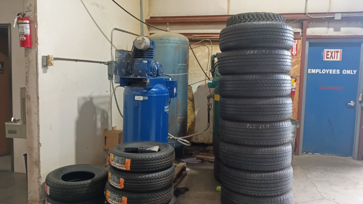 Tire service equipment and stacked tires inside the Hillsboro shop