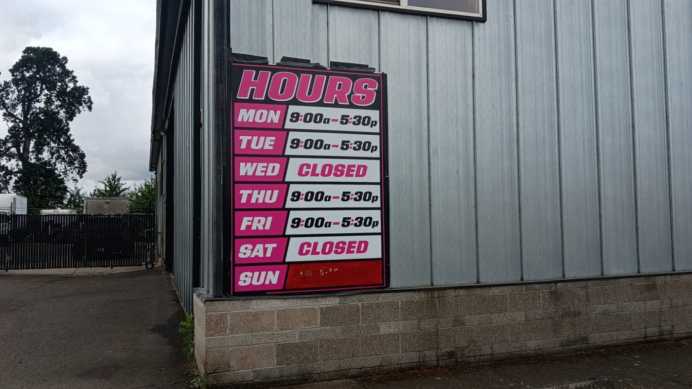 Hours sign at the Hubbard tire shop entrance