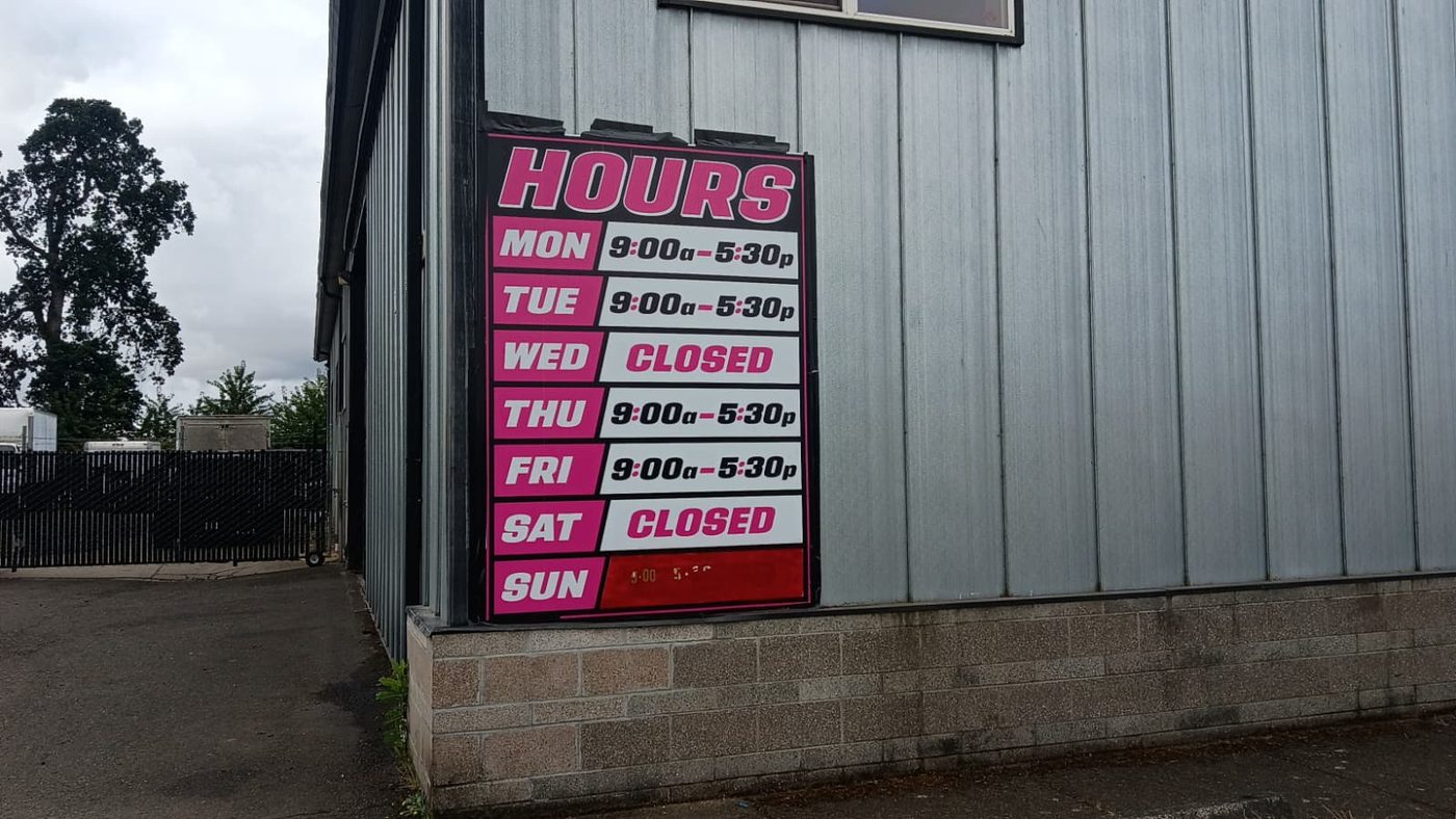 Hubbard shop exterior detail with posted hours